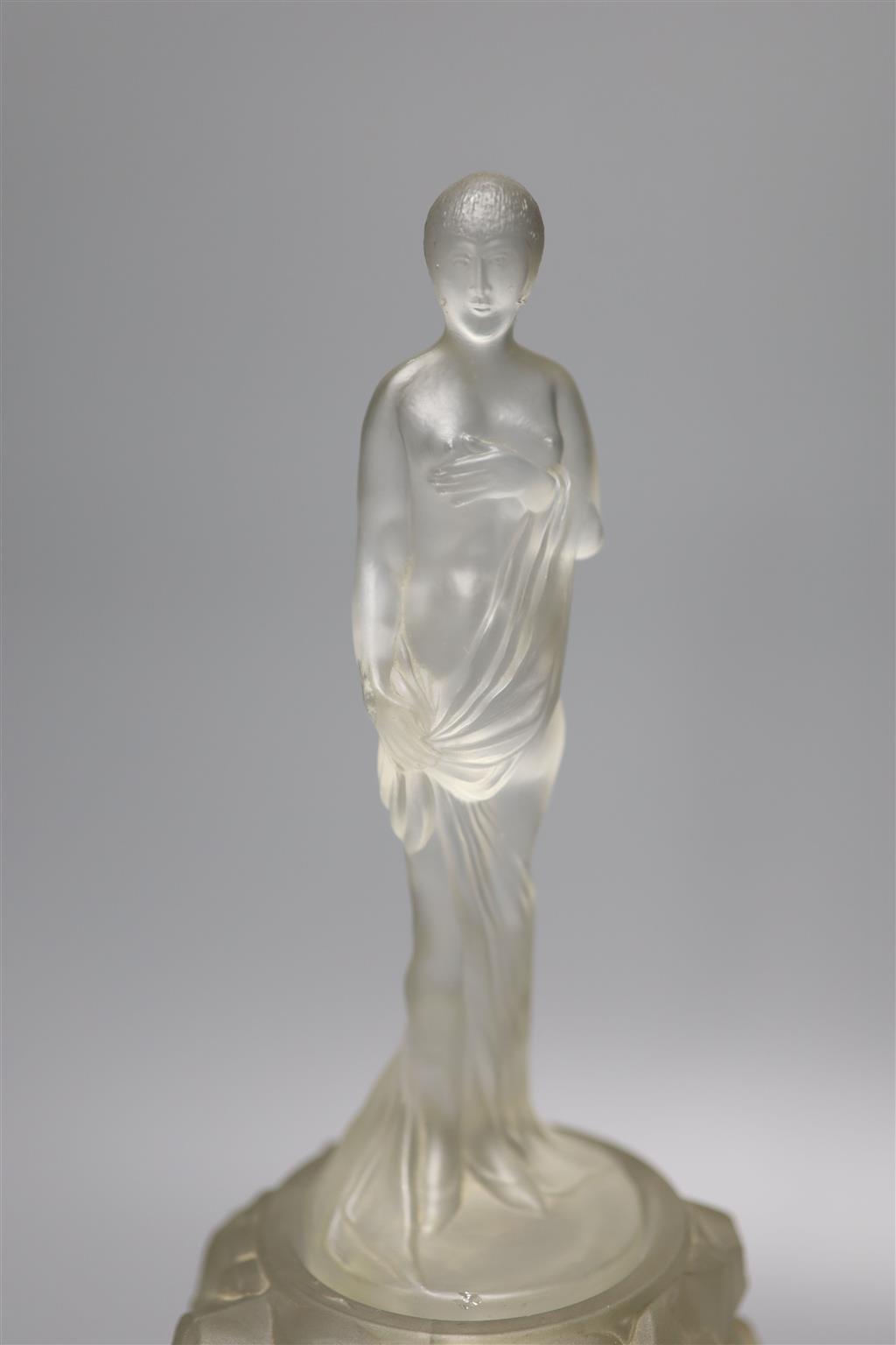 An Art Deco moulded glass figure on an illuminated glass stand